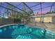 Inviting pool and spa with a covered patio and gorgeous sunset views at 608 69Th W Ave, Bradenton, FL 34207