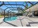 Inviting pool area with spa, screened enclosure, and ample seating at 608 69Th W Ave, Bradenton, FL 34207