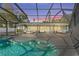 Expansive pool and spa with covered patio and seating area at 608 69Th W Ave, Bradenton, FL 34207