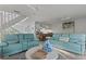 Living room with teal reclining sofas and a view into the kitchen at 6250 Holmes Blvd # 67, Holmes Beach, FL 34217