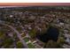 Aerial view of a house near a lake, showcasing the property and surrounding neighborhood at sunset at 6408 35Th W Ave, Bradenton, FL 34209