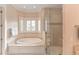 Spa-like bathroom featuring a soaking tub and glass shower enclosure at 641 Key Royale Dr, Holmes Beach, FL 34217