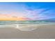 Stunning sunset over the ocean with colorful clouds and tranquil waves at 641 Key Royale Dr, Holmes Beach, FL 34217