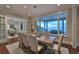 Bright dining room with hardwood floors and large windows overlooking the water at 641 Key Royale Dr, Holmes Beach, FL 34217
