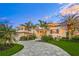 Stunning waterfront home showcasing a beautiful exterior at sunset at 641 Key Royale Dr, Holmes Beach, FL 34217
