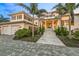 Elegant waterfront home with a three-car garage and manicured landscaping at 641 Key Royale Dr, Holmes Beach, FL 34217