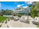 Relaxing fire pit area with comfortable seating, overlooking the house and pool at 641 Key Royale Dr, Holmes Beach, FL 34217