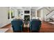 Open living room with fireplace, built-in shelving, and hardwood floors at 641 Key Royale Dr, Holmes Beach, FL 34217