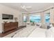 Main bedroom with stunning water views and a large bed at 641 Key Royale Dr, Holmes Beach, FL 34217