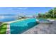 Large saltwater pool and spa with a beautiful view of the water at 641 Key Royale Dr, Holmes Beach, FL 34217