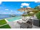 Relax by the pool with the tranquil water view and comfortable lounge chairs at 641 Key Royale Dr, Holmes Beach, FL 34217