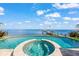 Stunning pool and spa with a central fountain, overlooking the water at 641 Key Royale Dr, Holmes Beach, FL 34217