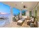 Relaxing waterfront porch with wicker furniture, offering stunning sunset views at 641 Key Royale Dr, Holmes Beach, FL 34217