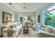 Light-filled sitting room, featuring a sofa and armchairs at 641 Key Royale Dr, Holmes Beach, FL 34217