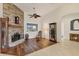 Cozy living room with a stone fireplace, hardwood floors, and a comfy seating area at 6511 Americana Ave, North Port, FL 34291