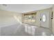 Bright living room with terrazzo flooring and a large window at 6712 Georgia Ave, Bradenton, FL 34207