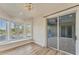 Serene bedroom featuring a bay window, hardwood floors, and access to a private balcony at 6779 Ashley Ct, Sarasota, FL 34241