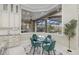 Bright breakfast nook with a glass table, backyard views, and modern cabinetry at 6779 Ashley Ct, Sarasota, FL 34241