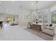 Spacious dining area adjacent to living room with modern decor and large windows at 6779 Ashley Ct, Sarasota, FL 34241