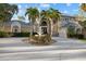 An elegant home featuring an elegant water fountain, detailed archways, and a well-maintained front yard at 6779 Ashley Ct, Sarasota, FL 34241