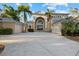 Impressive two-story home with an arched entryway, dual garages, and a spacious concrete driveway at 6779 Ashley Ct, Sarasota, FL 34241