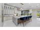 Bright kitchen with an island, a breakfast bar, white cabinets, and modern lighting at 6779 Ashley Ct, Sarasota, FL 34241