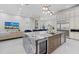 Open concept kitchen and living room with island seating, modern appliances, and lots of light at 6779 Ashley Ct, Sarasota, FL 34241