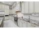 Modern kitchen features white cabinets, granite countertops and stainless steel appliances at 6779 Ashley Ct, Sarasota, FL 34241
