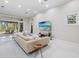 Bright living room featuring neutral tones and sliding doors to the outside entertainment area at 6779 Ashley Ct, Sarasota, FL 34241