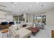 Spacious living room featuring a large seating area, kitchen, and sliding glass doors to the outdoor area at 6779 Ashley Ct, Sarasota, FL 34241