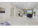Bright and airy living room with tile flooring, modern furniture, and a sliding glass door with outdoor view at 6779 Ashley Ct, Sarasota, FL 34241