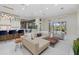 Spacious living room featuring a large seating area, kitchen, and sliding glass doors to the outdoor area at 6779 Ashley Ct, Sarasota, FL 34241