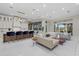 Spacious living room featuring a large seating area, kitchen, and sliding glass doors to the outdoor area at 6779 Ashley Ct, Sarasota, FL 34241