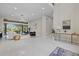 Spacious living room with modern lighting, decor, and a sliding glass door leading to the patio and pool at 6779 Ashley Ct, Sarasota, FL 34241