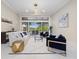 Cozy living room includes modern furniture, and access to outdoor patio with a relaxing pool view at 6779 Ashley Ct, Sarasota, FL 34241