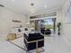 Bright living room with modern lighting, a sliding glass door, and stylish furniture at 6779 Ashley Ct, Sarasota, FL 34241