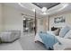 Elegant main bedroom featuring a four-poster bed, sitting area, and sliding doors to the outside area at 6779 Ashley Ct, Sarasota, FL 34241