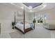 Elegant main bedroom featuring a four-poster bed, tray ceiling, and a large bay window with natural light at 6779 Ashley Ct, Sarasota, FL 34241