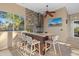 This outdoor kitchen has bar seating, granite countertops, stainless appliances, stone accent wall, and a mounted television at 6779 Ashley Ct, Sarasota, FL 34241