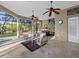 A screened-in patio features a seating area, outdoor kitchen, and a beautiful outdoor pool area at 6779 Ashley Ct, Sarasota, FL 34241