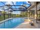 Serene screened pool with a spa and natural surroundings, offering a private outdoor oasis for relaxation at 6779 Ashley Ct, Sarasota, FL 34241
