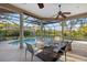 An outdoor pool is surrounded by a screened-in enclosure with an adjacent seating area and view of the backyard at 6779 Ashley Ct, Sarasota, FL 34241