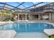 Beautiful screened pool area with a spa, outdoor seating, and seamless access to the home's living spaces at 6779 Ashley Ct, Sarasota, FL 34241
