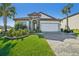 House exterior featuring a two-car garage and well-manicured lawn at 8303 Dove Bog Ter, Parrish, FL 34219