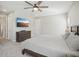 Main bedroom with king-size bed, dresser, and access to the bathroom at 8303 Dove Bog Ter, Parrish, FL 34219