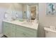 Shared bathroom with dual sinks and light green vanity at 901 30Th E Ct, Bradenton, FL 34208