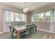 Light and airy dining room with wooden table and teal chairs at 901 30Th E Ct, Bradenton, FL 34208