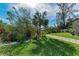 Landscaped front yard with a stone pathway, lush greenery, and palm trees at 901 30Th E Ct, Bradenton, FL 34208