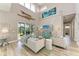 Bright living room with high ceilings, hardwood floors, and access to a patio at 901 30Th E Ct, Bradenton, FL 34208