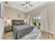 Main bedroom with king-size bed, sliding doors to the patio, and a ceiling fan at 901 30Th E Ct, Bradenton, FL 34208